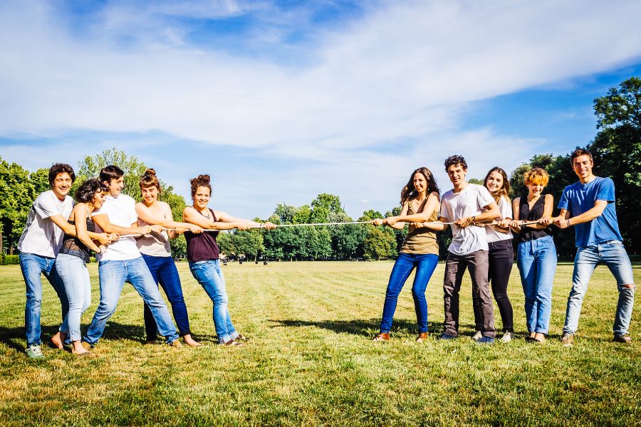 team members play tug of war